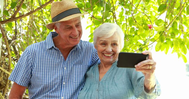 Senior couple using smartphone outdoor
