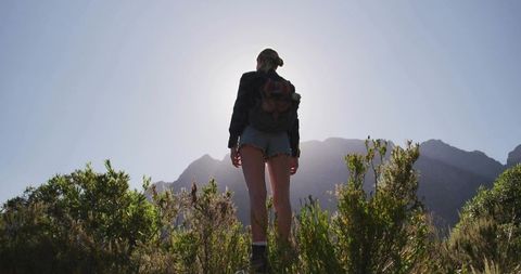 Solo Hiker Trekking through Rugged Mountain Landscape