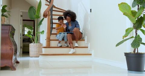 Mother and Son Sharing a Nice Moment on Wooden Stairs