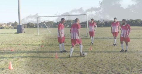 Amateur Soccer Team Practicing Dribbling Drill with Cones on Community Field