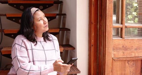 Woman on Spiral Staircase Contemplating by Window Light