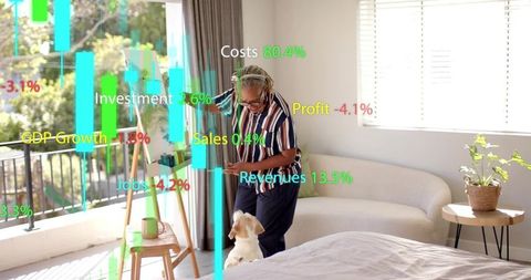 Senior woman petting dog interacting with augmented reality financial charts in sunlit bedroom