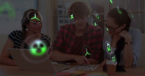 Team collaborating with augmented reality icons over laptop pointing at design printout