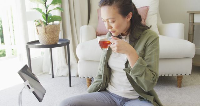 Woman Relaxing with Tea and Using Tablet at Home - Download Free Stock Images Pikwizard.com