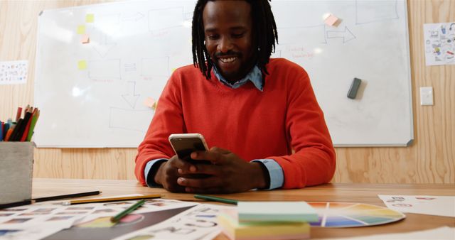 Smiling Designer Checking Smartphone in Creative Office - Download Free Stock Images Pikwizard.com