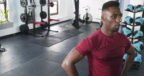 Athlete Posing Confidently in Modern Gym Environment