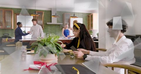 Young professionals collaborating in office kitchen with handshake and mobile devices