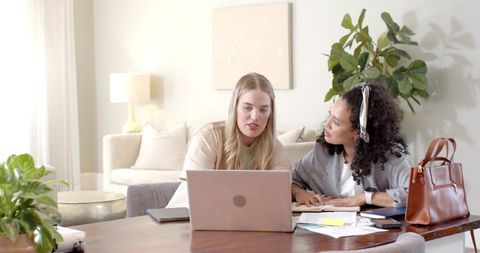 Diverse Women Collaborating in Modern Living Room Workspace