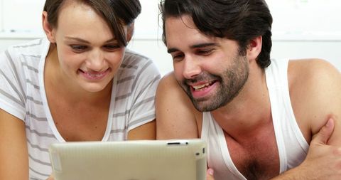 Happy Couple Enjoying Tablet Together at Home - Download Free Stock Images Pikwizard.com