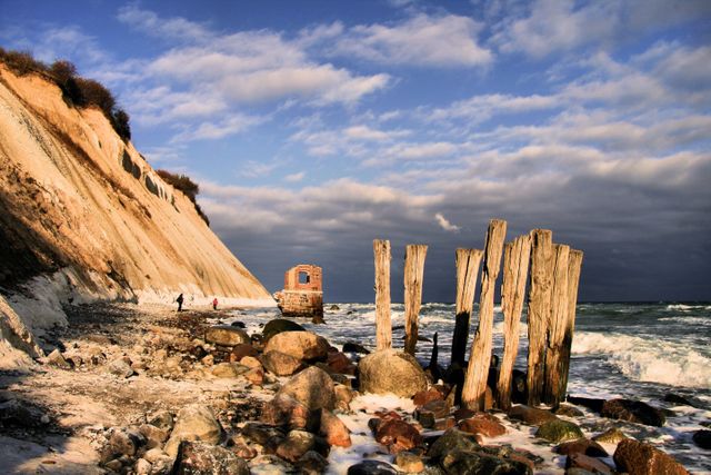 Rustic Coastal Scene with Cliffs and Wooden Piers at Sunset - Download Free Stock Photos Pikwizard.com