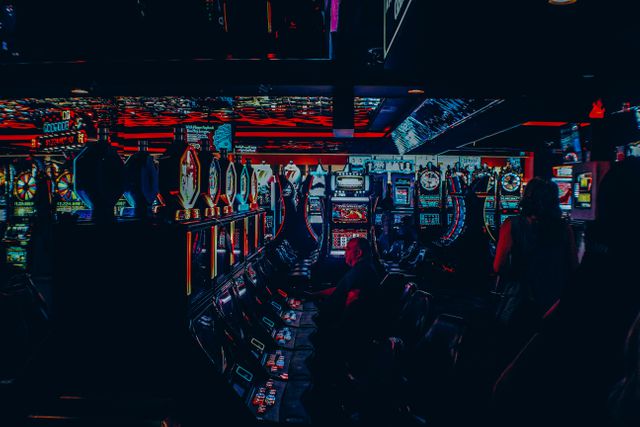 Neon-lit Casino Interior with Slot Machines in Evening - Download Free Stock Photos Pikwizard.com
