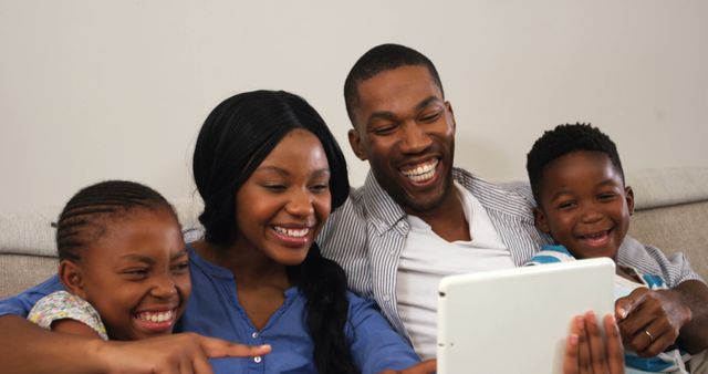 Happy African American Family Smiling And Using Tablet At Home - Download Free Stock Images Pikwizard.com