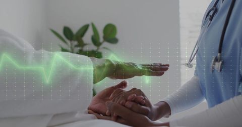 Nurse Comforting Patient with Cardiograph Monitor Display