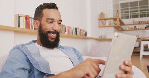 Man Relaxing While Using Tablet at Home