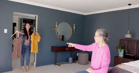 Mother Choosing Dress Daughter Holding Choice Homemaking