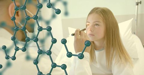 Pediatrician examining child eye with penlight and molecular overlay for clinic research