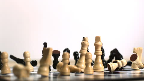 Dramatic Chess Piece Capture in Motion on Backlit Board