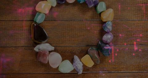 Colorful Ring of Polished Semi-Precious Stones on Wooden Surface