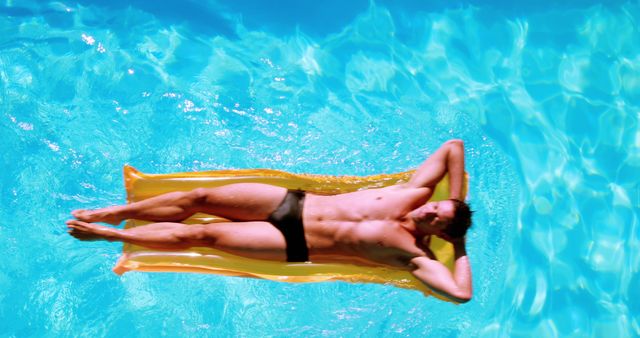 Man Relaxing on Inflatable Mat in Swimming Pool Under Sunlight - Download Free Stock Images Pikwizard.com