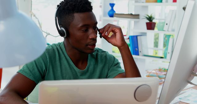 Young Man Working from Home with Headset and Laptop - Download Free Stock Images Pikwizard.com