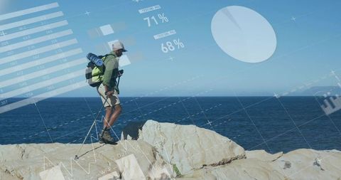 Hiker surveying coastal cliff with backpack and trekking poles, hud analytics overlay