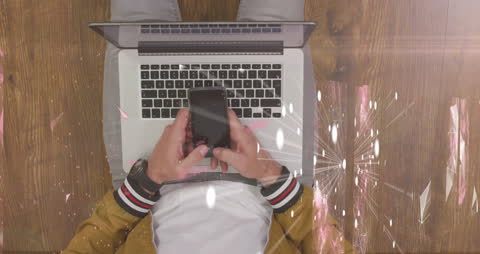 Top View of Man Using Smartphone and Laptop with Digital Overlays