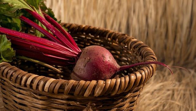Fresh Beetroot in Rustic Wicker Basket on Straw Background