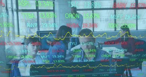 Financial analysts collaborating in modern office with stock market data
