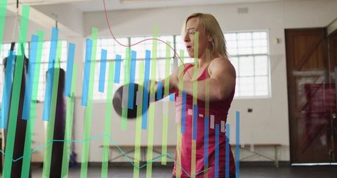 Female Athlete Swinging Kettlebell in Gym with Fitness Data Overlay and Performance Metrics