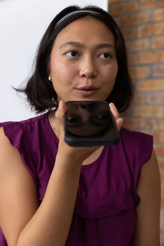 Professional communication using smartphone in modern office environment