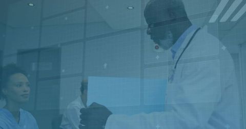 Doctor Discussing Medical Records with Colleagues in Modern Clinic