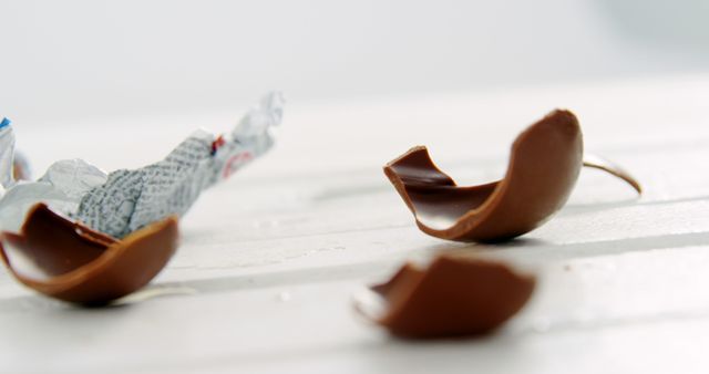 Broken chocolate pieces are an ideal subject for advertisements, websites, or social media posts related to confectionery, desserts, or holiday treats. The close-up detail makes it perfect for illustrating recipes or candy branding.