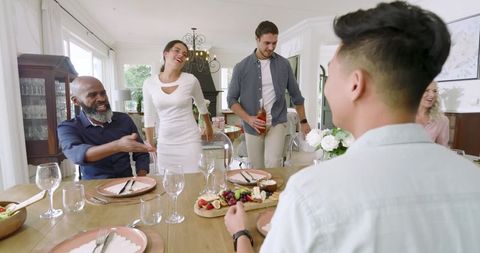 Diverse family gathering around dining table for celebration
