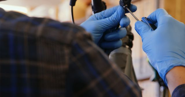 Technician Wearing Blue Gloves Repairing Electronics Device - Download Free Stock Images Pikwizard.com