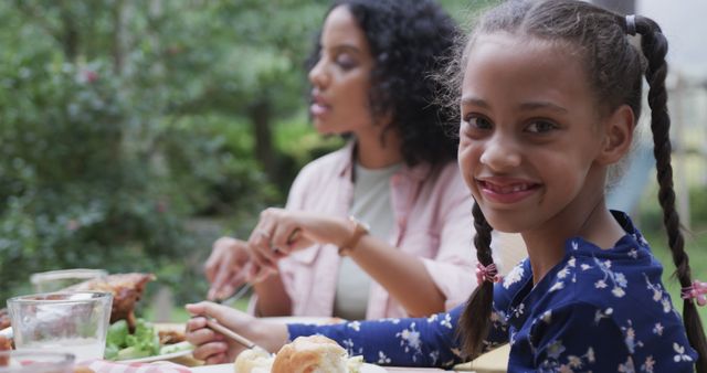 Smiling Girl Enjoying Outdoor Family Meal - Download Free Stock Images Pikwizard.com