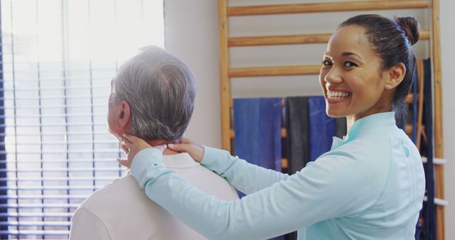 Smiling physiotherapist treating senior patient in clinic - Download Free Stock Images Pikwizard.com