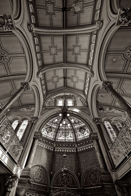 Historic Gothic architectural interior showing ornate details on ceiling and columns. Perfect for educational materials, history blogs, travel websites, and architectural studies.