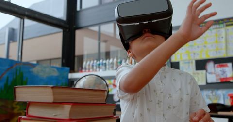 Schoolboy using virtual reality in interactive classroom experience