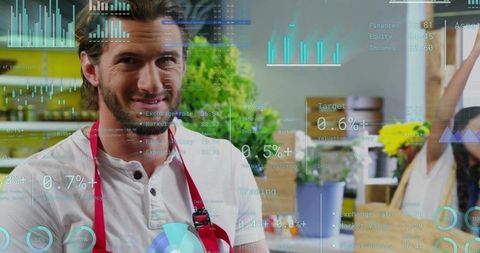 Smiling barista wearing red apron and white henley standing in cozy cafe with data hud