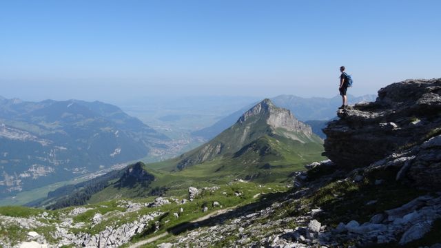 Hiker Standing on Rock Overlooking Mountainous Landscape - Download Free Stock Photos Pikwizard.com