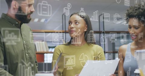 Creative business team collaborating with digital icons overlay