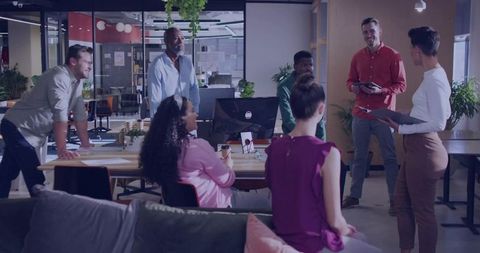 Diverse Team Collaborating in Modern Office, Discussing Strategies