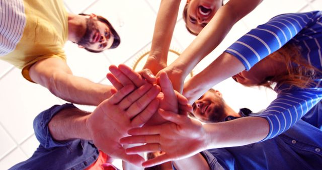 Group image of people joining hands in circle symbolizing teamwork and collaboration. Useful for illustrating concepts related to unity, corporate team building, group work, and mutual support. Suitable for advertisements, corporate presentations, teamwork workshops, and community or motivational events.