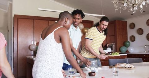 Diverse Group of Friends Socializing in Modern Kitchen