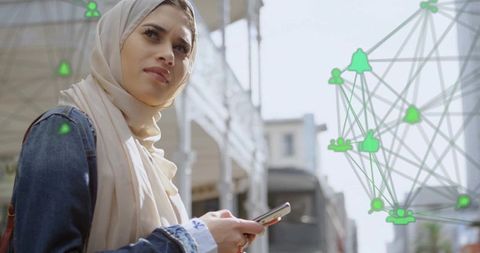 Connected Future: Woman in Hijab with Smartphone and Digital Network