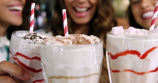 Group of Friends Enjoying Delicious Milkshakes with Whipped Cream and Straws - Download Free Stock Images Pikwizard.com