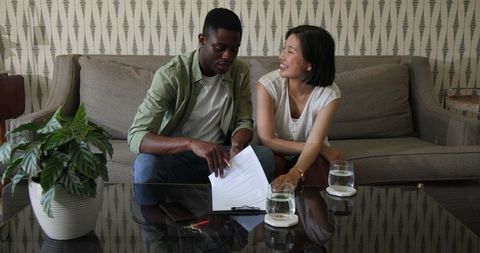 Happy couple discussing wedding plans at home