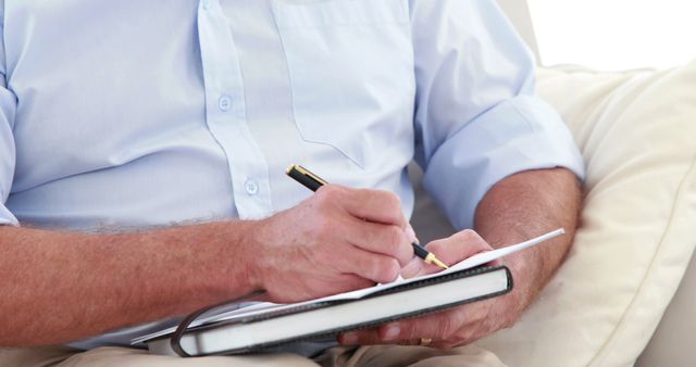 Senior Man Writing in Notebook at Home - Download Free Stock Images Pikwizard.com