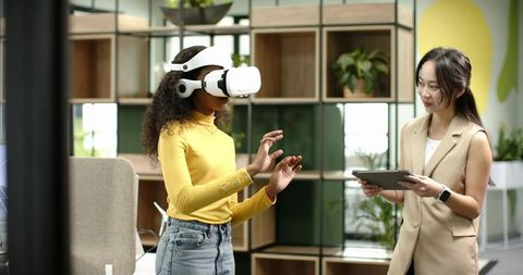 Diverse Professionals Using VR and Digital Tablet in Modern Office