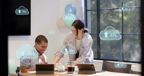 Team collaborating over tablets with ar cloud uploads, cake and office celebration